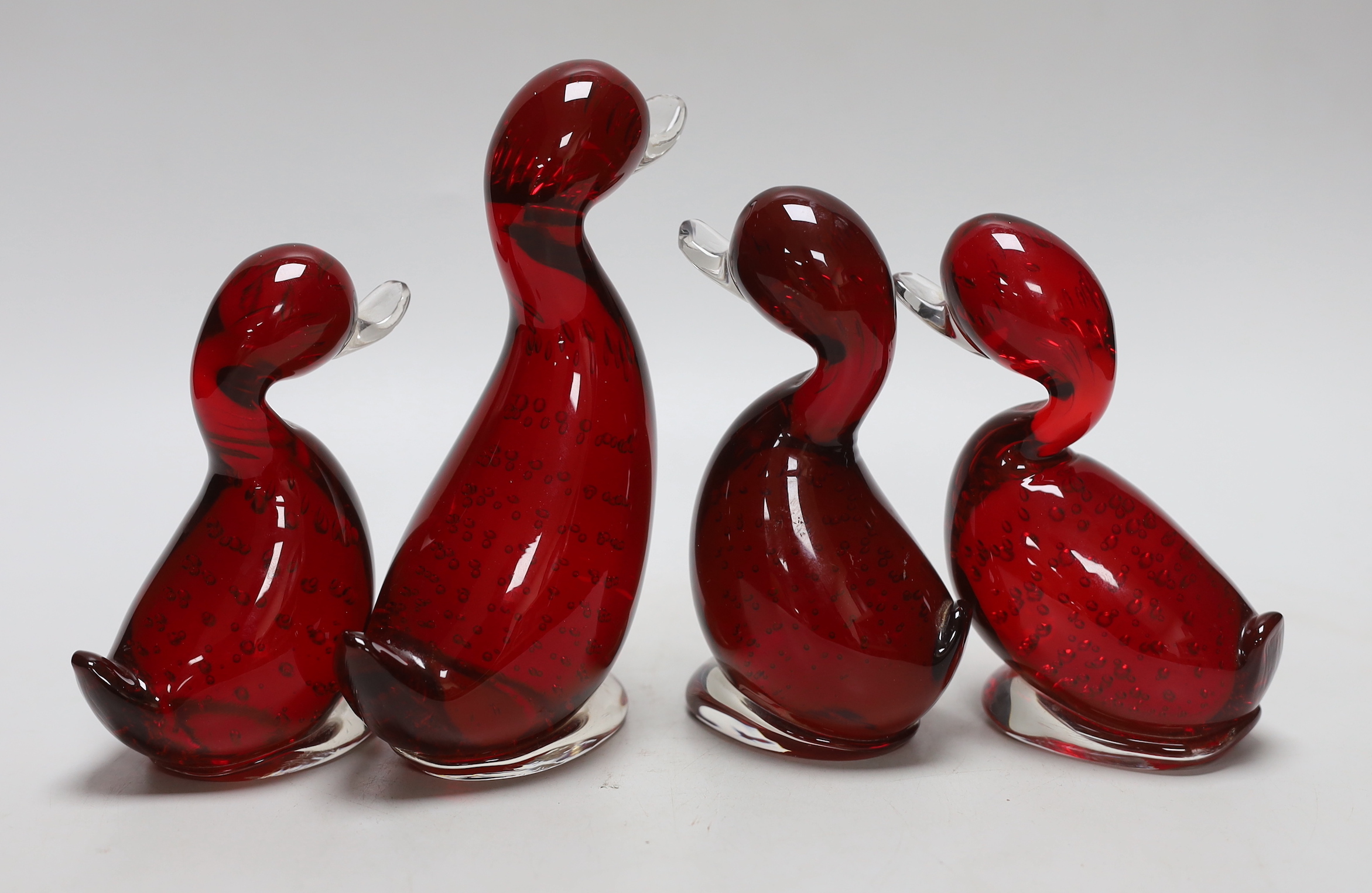 Four Whitefriars ruby glass ducks, tallest 18cm high